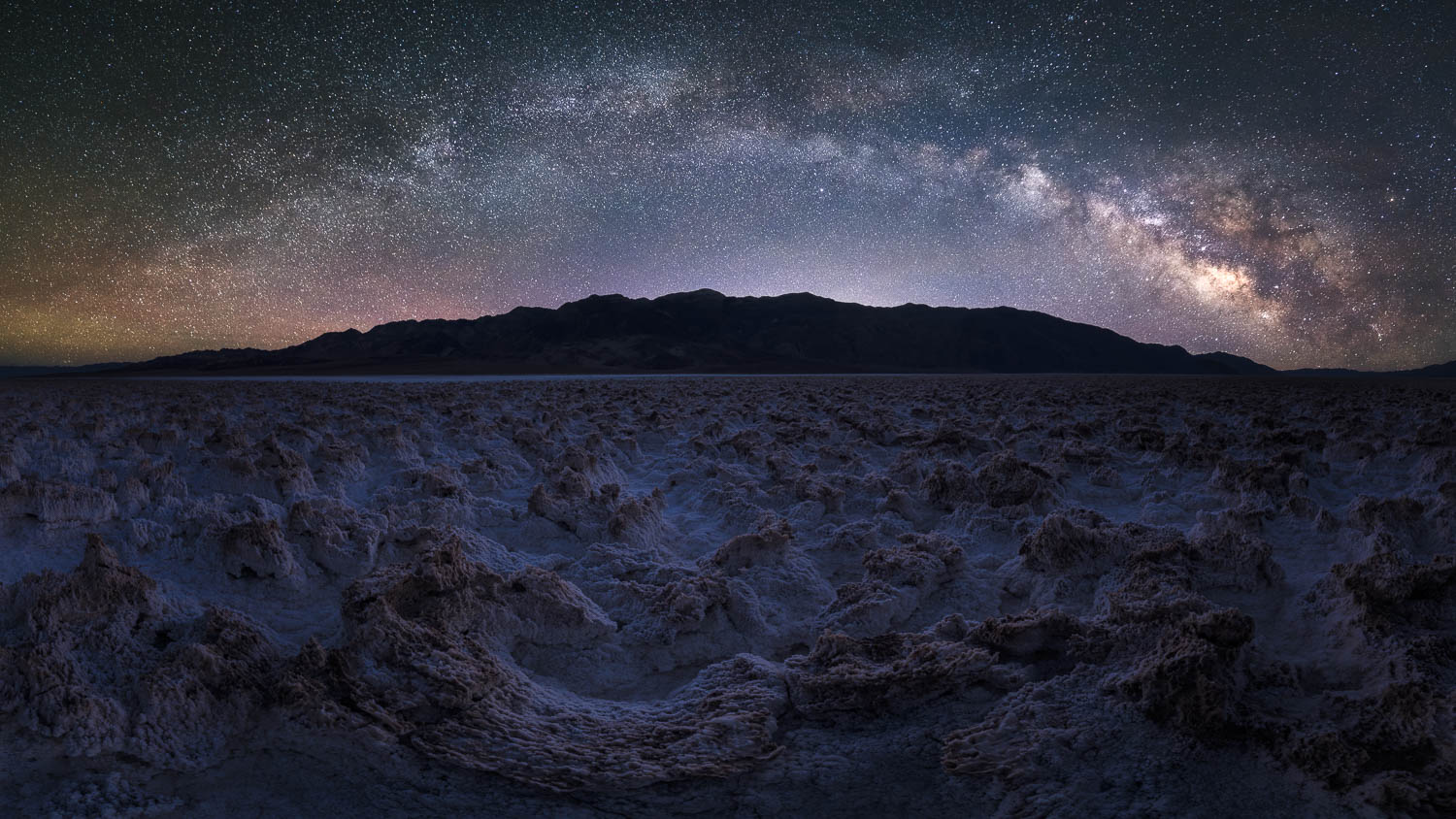 Milky Way Panorama in Death Valley galactic core of the milky way in starry night sky over gnarled salt flats