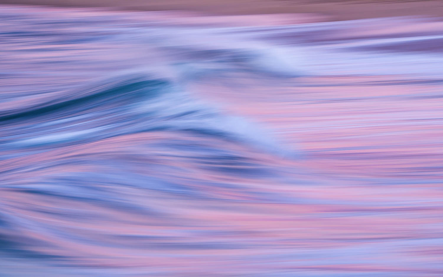 The Shape of Waves intentionally blurred wave in pink and blue hues