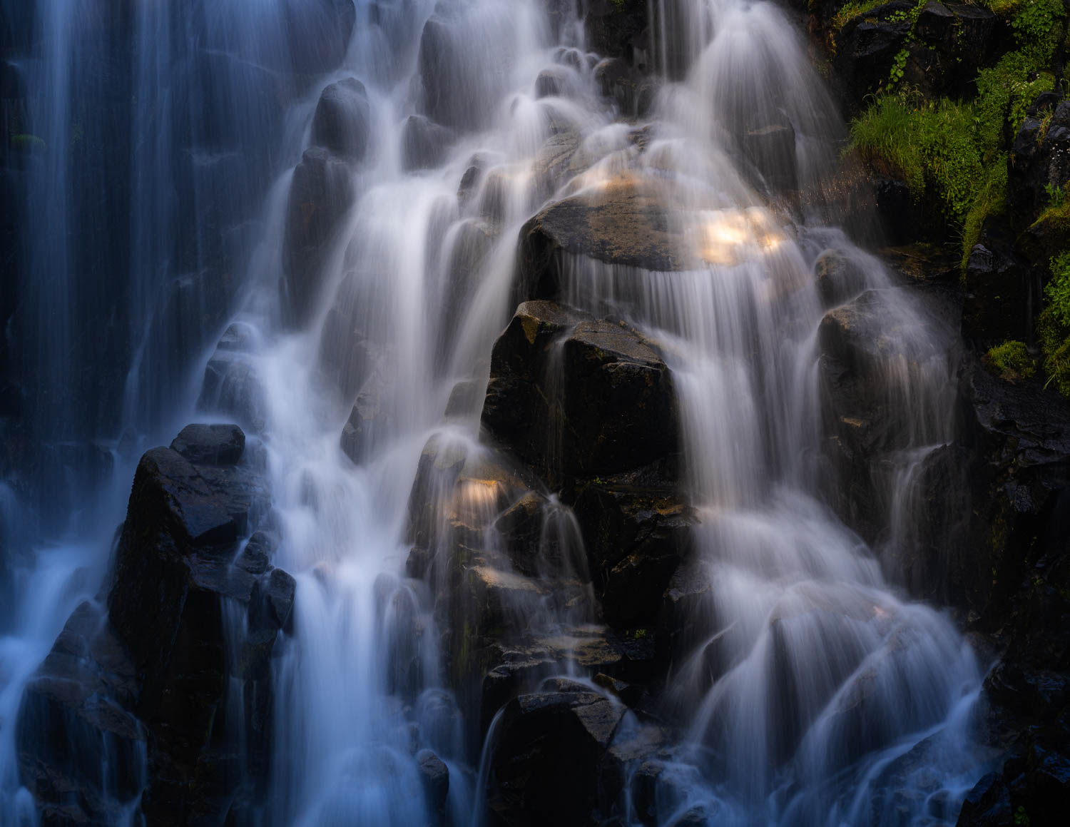 Myrtle’s Magic glints of warm light on silky smooth waterfall and dark rocks