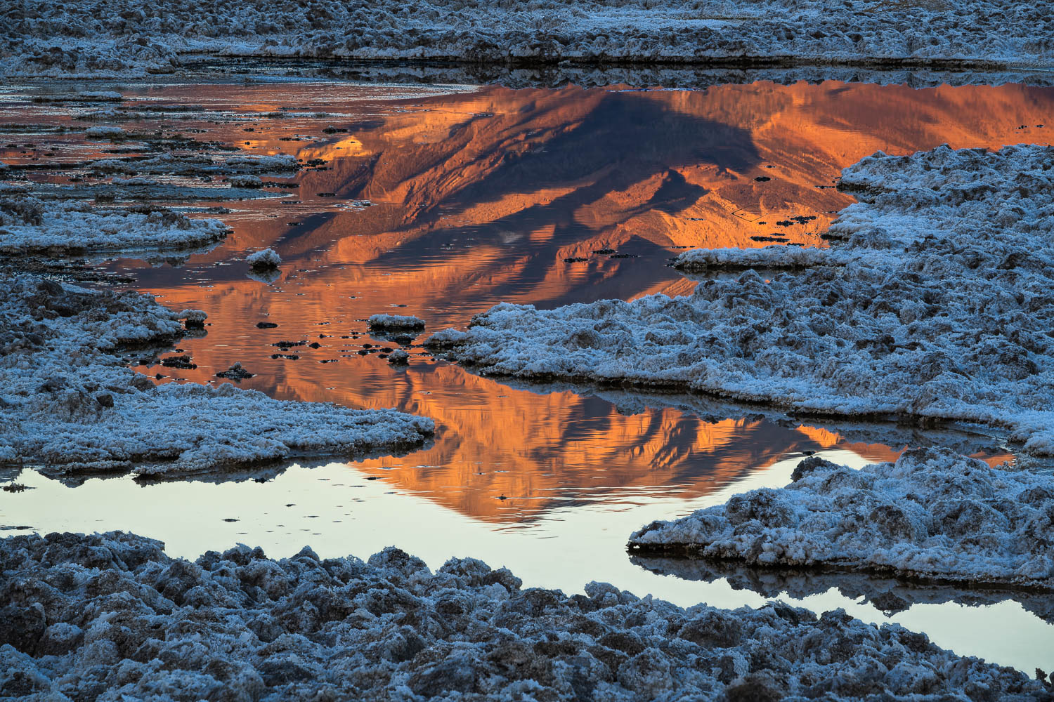 Mountain Framed in Salt golden mountain reflection framed by overlapping salt formations